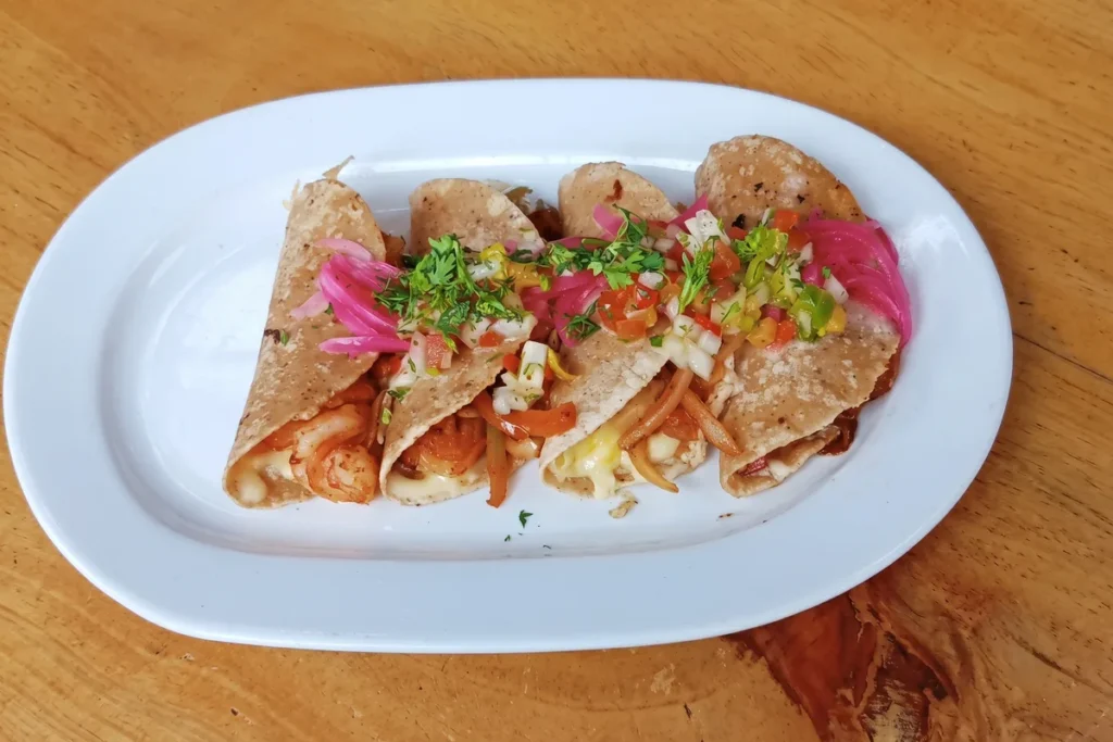 Plato blanco con cuatro tacos gobernador de camarón y queso servidos en restaurante en Chía.