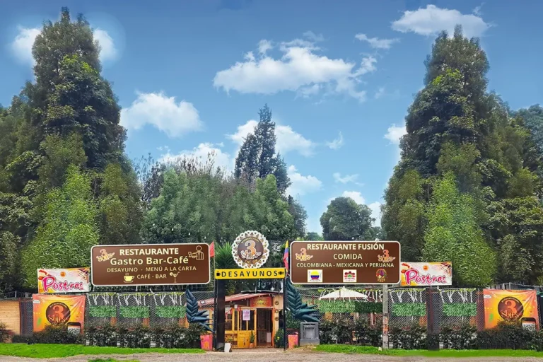 Main entrance of 3 soles fusion restaurant in chia with promotional signs and tall trees in the background.