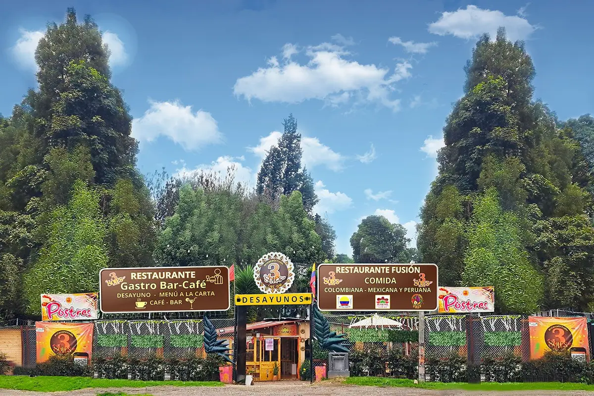 Main entrance of 3 soles fusion restaurant in chia with promotional signs and tall trees in the background.