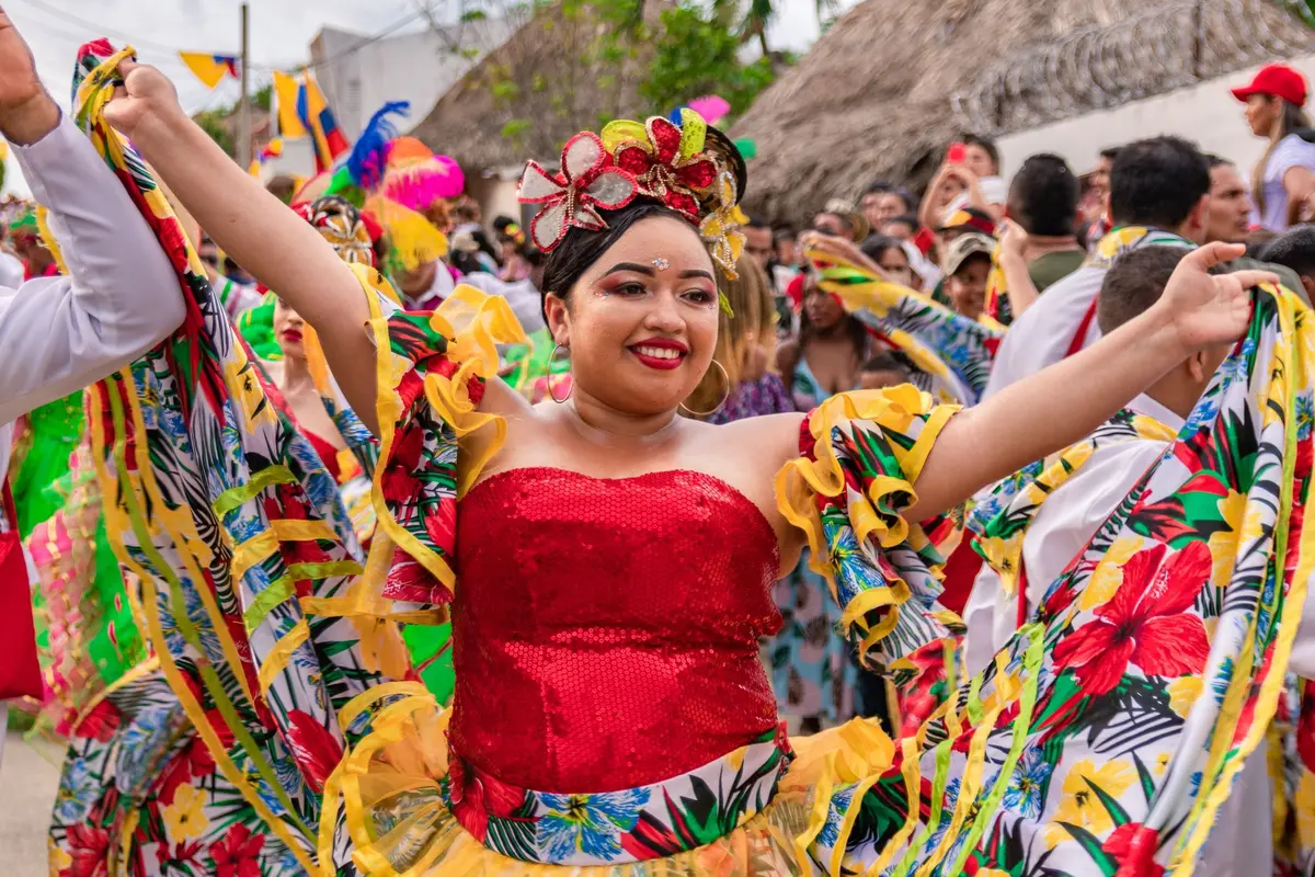 Woman dancing in a colorful traditional folklore costume during the cultural parade in chia.