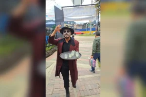 Waiter dressed as catrin serving drinks during day of the dead event at a restaurant in chia.