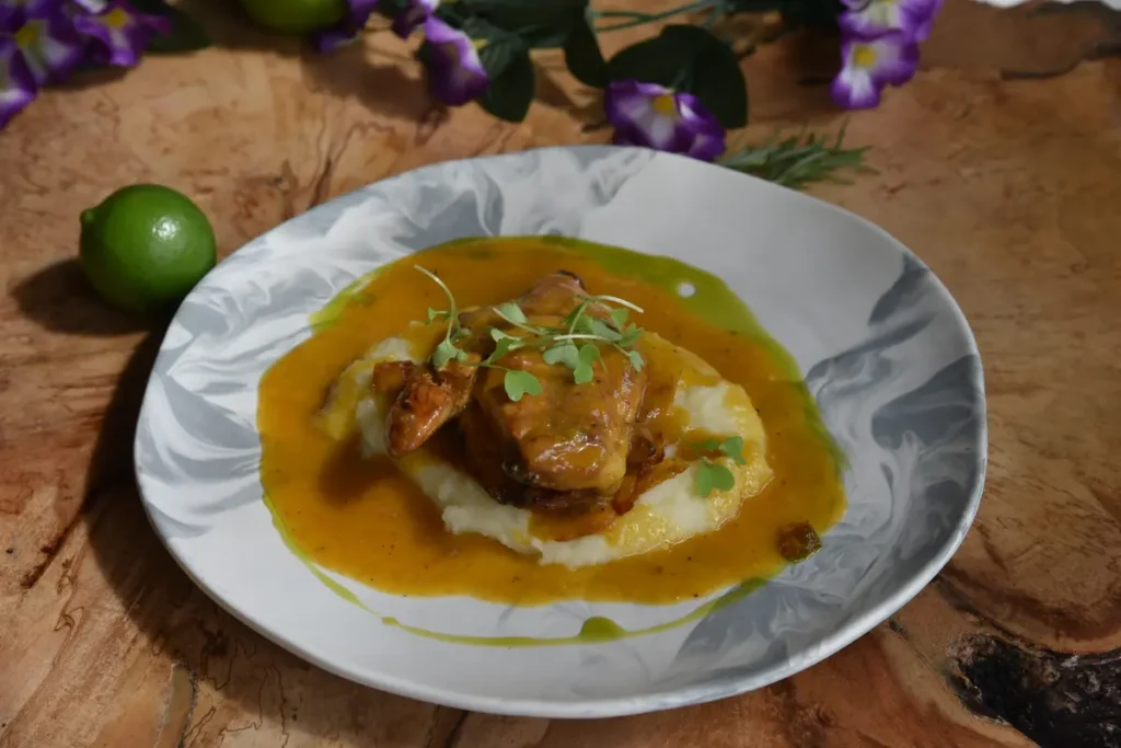 Plato gourmet de carne sobre puré con salsa de uchuva preparado con ingredientes nativos colombianos.